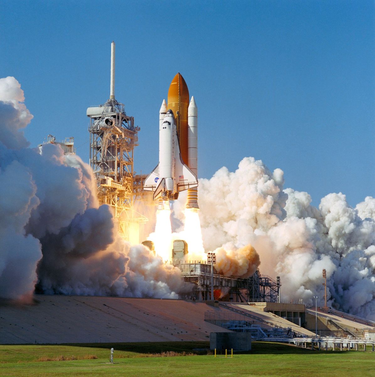 Space shuttle Discovery rising from the launch pad on the STS-95 mission.