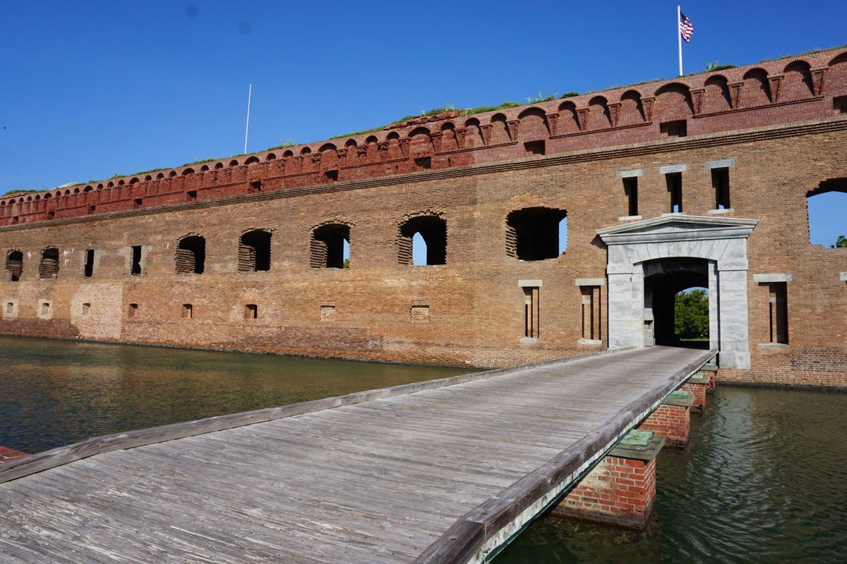 A walkway crossing the moat to the brick sallyport entrance of Fort Jefferson.